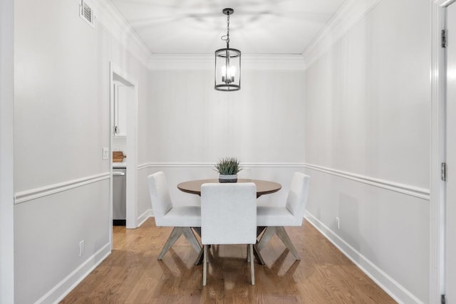 416 Sloan Rd, Nashville, TN 37209 - dining room featuring wood finished floors, ornamental molding, and a chandelier