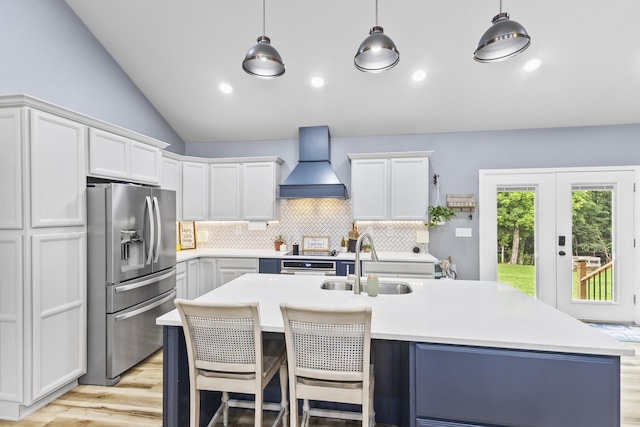 1567 Oak Knob Rd, Lafayette, TN 37083 - kitchen with stainless steel fridge with ice dispenser, custom exhaust hood, light wood finished floors, lofted ceiling, and light countertops