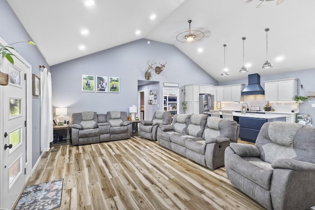 1567 Oak Knob Rd, Lafayette, TN 37083 - living area with light wood-type flooring, high vaulted ceiling, recessed lighting, and healthy amount of natural light