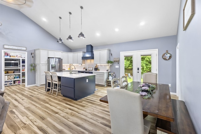 1567 Oak Knob Rd, Lafayette, TN 37083 - kitchen with wall chimney exhaust hood, stainless steel refrigerator with ice dispenser, french doors, light countertops, and white cabinets