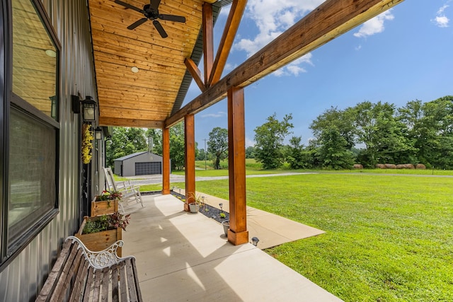 1567 Oak Knob Rd, Lafayette, TN 37083 - view of patio featuring a ceiling fan, an outbuilding, and view of wooded area