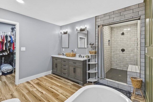 1567 Oak Knob Rd, Lafayette, TN 37083 - bathroom with tiled shower, double vanity, a bath, and wood finished floors