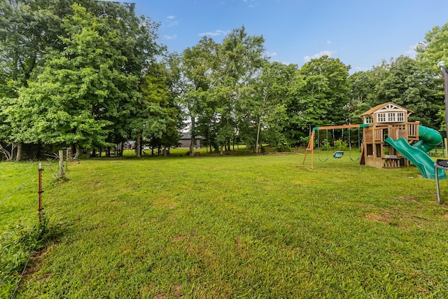 1567 Oak Knob Rd, Lafayette, TN 37083 - view of green lawn featuring a playground and view of wooded area