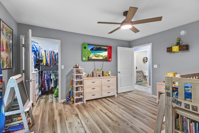1567 Oak Knob Rd, Lafayette, TN 37083 - bedroom featuring light wood-style flooring, a spacious closet, a closet, and a ceiling fan