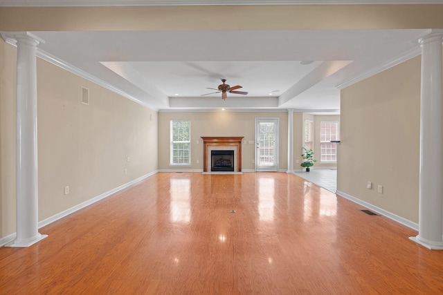 1729 Dryden Dr, Spring Hill, TN 37174 - unfurnished living room with decorative columns, a ceiling fan, a tray ceiling, and wood finished floors
