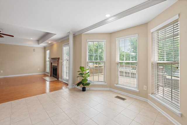 1729 Dryden Dr, Spring Hill, TN 37174 - unfurnished living room with a ceiling fan, ornate columns, light tile patterned floors, crown molding, and a fireplace with flush hearth