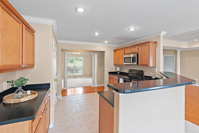 1729 Dryden Dr, Spring Hill, TN 37174 - kitchen with black electric range, ornate columns, stainless steel microwave, crown molding, and dark countertops