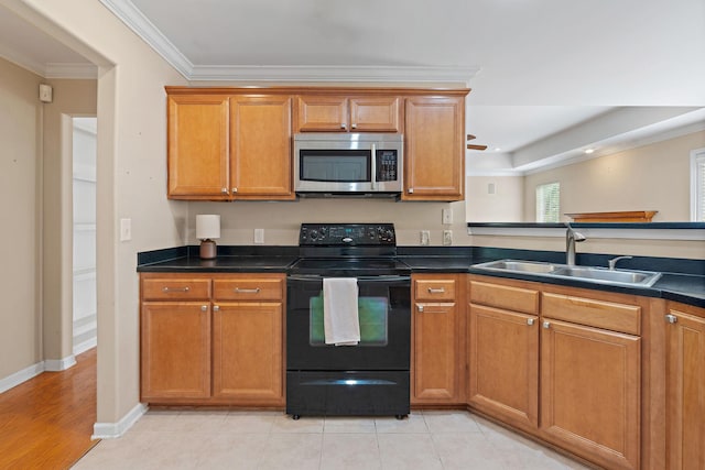 1729 Dryden Dr, Spring Hill, TN 37174 - kitchen featuring stainless steel microwave, black electric range oven, brown cabinets, and ornamental molding