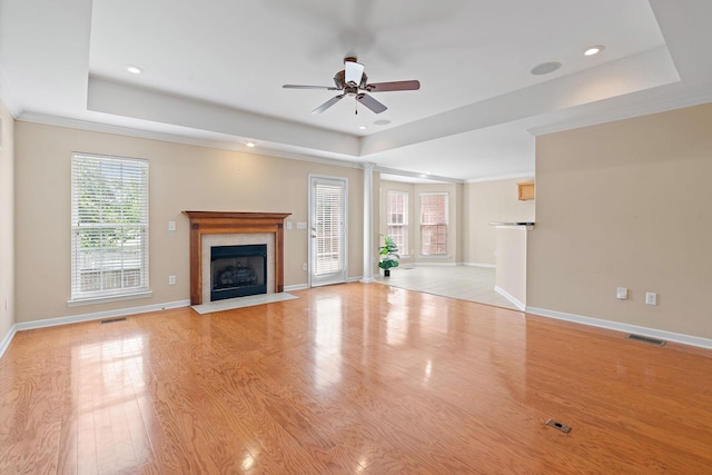 1729 Dryden Dr, Spring Hill, TN 37174 - unfurnished living room featuring a tray ceiling, a premium fireplace, a ceiling fan, light wood-type flooring, and recessed lighting