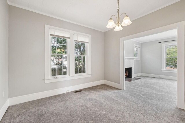 1221 W Commerce St W, Lewisburg, TN 37091 - empty room featuring carpet floors, crown molding, plenty of natural light, a chandelier, and a fireplace with flush hearth