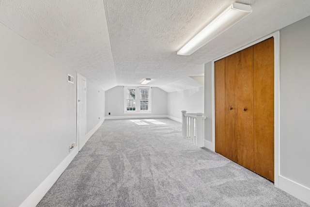 1221 W Commerce St W, Lewisburg, TN 37091 - bonus room featuring a textured ceiling, carpet, and vaulted ceiling