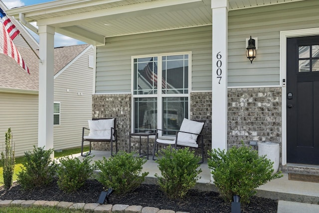 6007 Cavalry Ct, Spring Hill, TN 37174 - view of exterior entry with a porch, brick siding, and stone siding