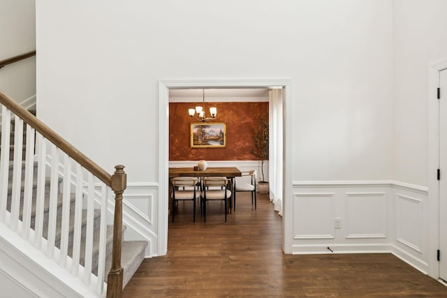 6007 Cavalry Ct, Spring Hill, TN 37174 - dining room featuring a wainscoted wall, stairway, dark wood-style floors, a chandelier, and a decorative wall