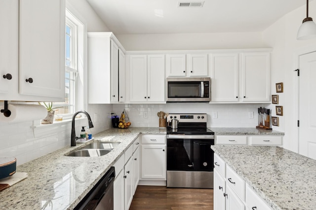 6007 Cavalry Ct, Spring Hill, TN 37174 - kitchen with stainless steel appliances, decorative backsplash, white cabinetry, and healthy amount of natural light