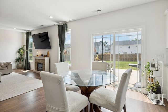 6007 Cavalry Ct, Spring Hill, TN 37174 - dining space featuring plenty of natural light, dark wood-style floors, a glass covered fireplace, and recessed lighting
