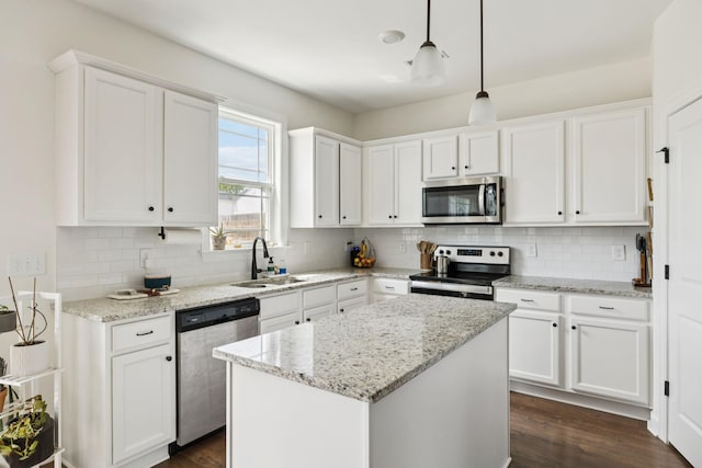 6007 Cavalry Ct, Spring Hill, TN 37174 - kitchen with appliances with stainless steel finishes, white cabinets, tasteful backsplash, and dark wood-style floors