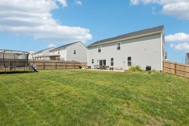 6007 Cavalry Ct, Spring Hill, TN 37174 - back of house featuring a trampoline, a patio, and a fenced backyard