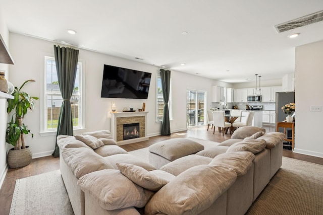 6007 Cavalry Ct, Spring Hill, TN 37174 - living area featuring a stone fireplace, wood finished floors, and recessed lighting