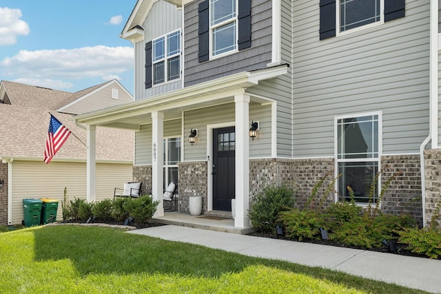 6007 Cavalry Ct, Spring Hill, TN 37174 - view of exterior entry featuring covered porch and a yard