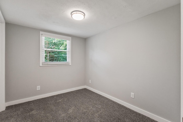 706 Poplar Ave, Murfreesboro, TN 37130 - empty room with dark colored carpet and a textured ceiling