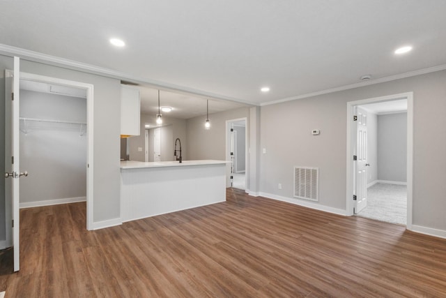 706 Poplar Ave, Murfreesboro, TN 37130 - unfurnished living room with wood finished floors, recessed lighting, and crown molding
