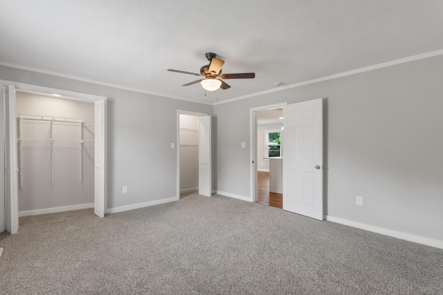 706 Poplar Ave, Murfreesboro, TN 37130 - unfurnished bedroom featuring ornamental molding, two closets, carpet floors, and ceiling fan