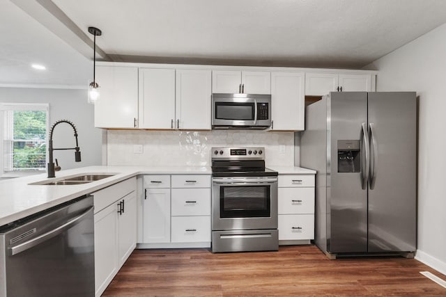 706 Poplar Ave, Murfreesboro, TN 37130 - kitchen with appliances with stainless steel finishes, white cabinets, light countertops, tasteful backsplash, and decorative light fixtures