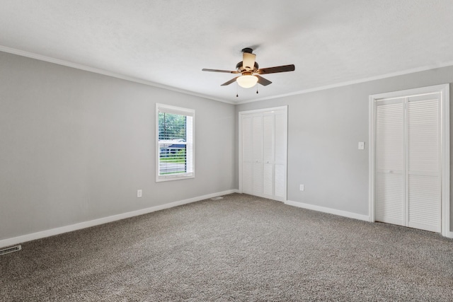 706 Poplar Ave, Murfreesboro, TN 37130 - unfurnished bedroom featuring ornamental molding, multiple closets, carpet floors, and ceiling fan