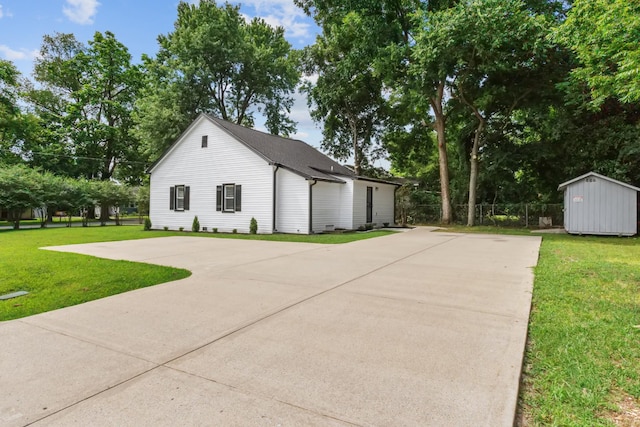 706 Poplar Ave, Murfreesboro, TN 37130 - view of side of property with a shed, a lawn, and concrete driveway