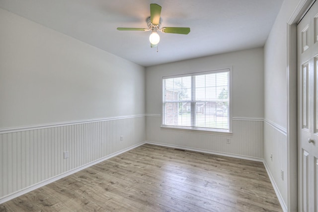 2902 Crenshaw Ct, Spring Hill, TN 37174 - empty room featuring light wood-style floors, wainscoting, and a ceiling fan