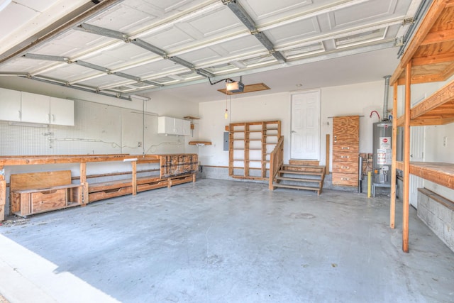 2902 Crenshaw Ct, Spring Hill, TN 37174 - garage featuring a workshop area, a garage door opener, and water heater