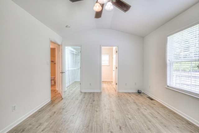 2902 Crenshaw Ct, Spring Hill, TN 37174 - unfurnished bedroom with a walk in closet, light wood-style flooring, lofted ceiling, ensuite bath, and a closet