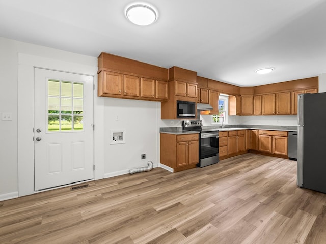 206 Elk Acre Dr, Estill Springs, TN 37330 - kitchen with appliances with stainless steel finishes, brown cabinets, light wood-type flooring, light countertops, and under cabinet range hood