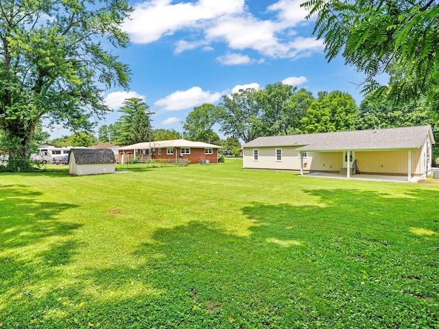 206 Elk Acre Dr, Estill Springs, TN 37330 - view of grassy yard featuring a storage unit and a patio