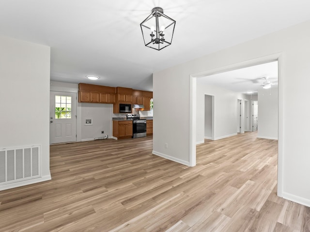 206 Elk Acre Dr, Estill Springs, TN 37330 - unfurnished living room featuring light wood-style flooring and a chandelier