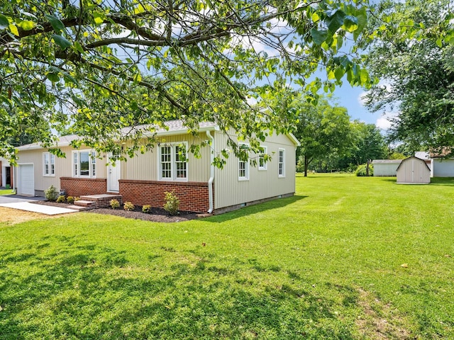 206 Elk Acre Dr, Estill Springs, TN 37330 - view of front of property featuring brick siding, a front yard, a storage unit, a garage, and board and batten siding