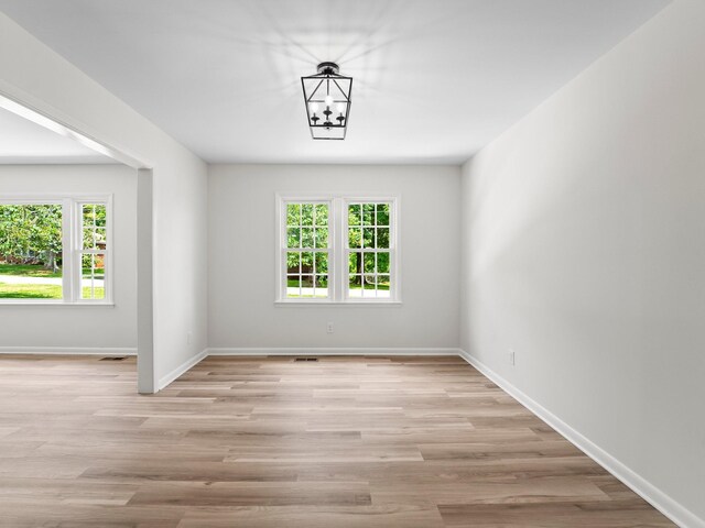 206 Elk Acre Dr, Estill Springs, TN 37330 - unfurnished room with healthy amount of natural light, light wood-style floors, and a chandelier