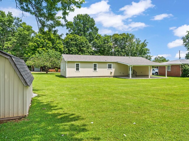 206 Elk Acre Dr, Estill Springs, TN 37330 - back of house featuring a lawn, a patio area, and a carport