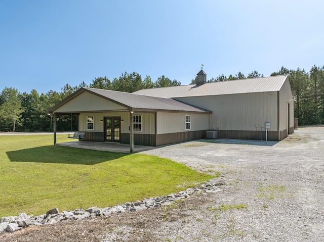 545 W 4th St, Parsons, TN 38363 - back of property with french doors, a yard, driveway, and a metal roof