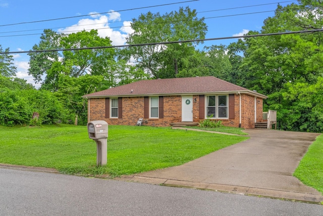 305 Barry Dr, Clarksville, TN 37040 - ranch-style house featuring brick siding, a front yard, concrete driveway, and roof with shingles
