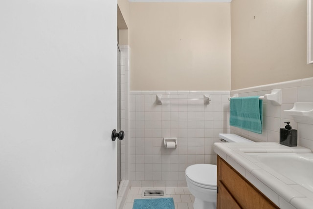305 Barry Dr, Clarksville, TN 37040 - full bathroom with tile walls, vanity, wainscoting, tile patterned floors, and a stall shower
