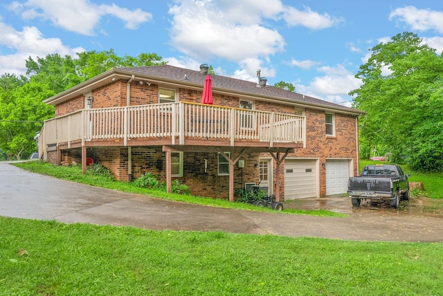 305 Barry Dr, Clarksville, TN 37040 - rear view of property featuring brick siding, asphalt driveway, a wooden deck, a garage, and a yard