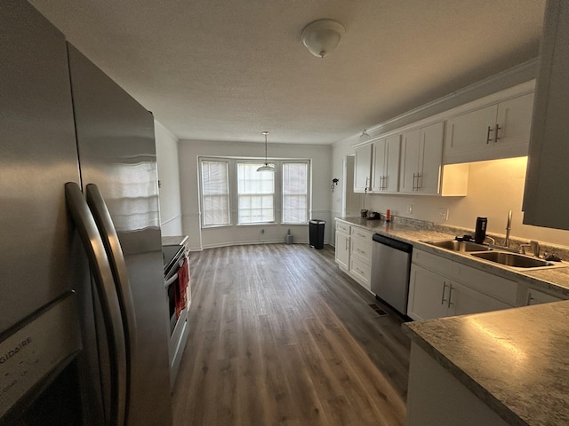 2519 Buckle St, Murfreesboro, TN 37129 - kitchen with stainless steel appliances, dark wood-style floors, white cabinets, and pendant lighting