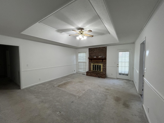 2519 Buckle St, Murfreesboro, TN 37129 - unfurnished living room with a tray ceiling, a fireplace, carpet floors, ceiling fan, and a textured ceiling