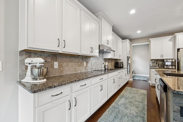 2229 Arbor Pointe Way, Hermitage, TN 37076 - kitchen featuring dark wood-style floors, under cabinet range hood, white cabinets, dark stone countertops, and black electric stovetop