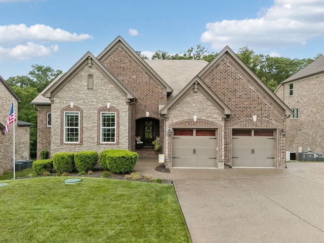 2229 Arbor Pointe Way, Hermitage, TN 37076 - view of front of house featuring driveway, a front yard, a garage, and brick siding