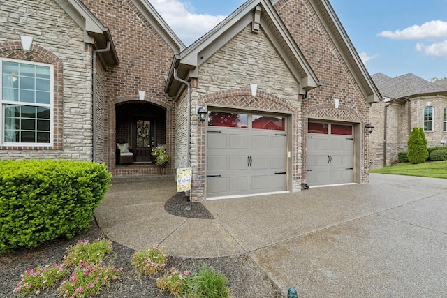 2229 Arbor Pointe Way, Hermitage, TN 37076 - view of front of home featuring concrete driveway, stone siding, a garage, and brick siding