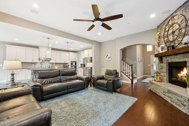 2229 Arbor Pointe Way, Hermitage, TN 37076 - living room with arched walkways, a ceiling fan, stairs, dark wood-style floors, and a fireplace