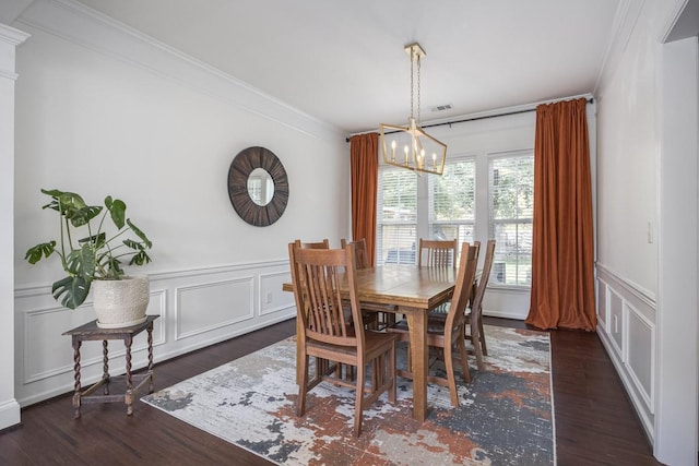 5925 Westheimer Dr, Brentwood, TN 37027 - dining space with crown molding, a chandelier, a decorative wall, dark wood-style flooring, and a wainscoted wall