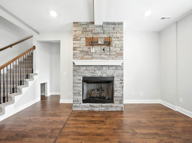 509 Kinslow Ln, Clarksville, TN 37040 - unfurnished living room featuring wood finished floors, stairway, a stone fireplace, beam ceiling, and recessed lighting